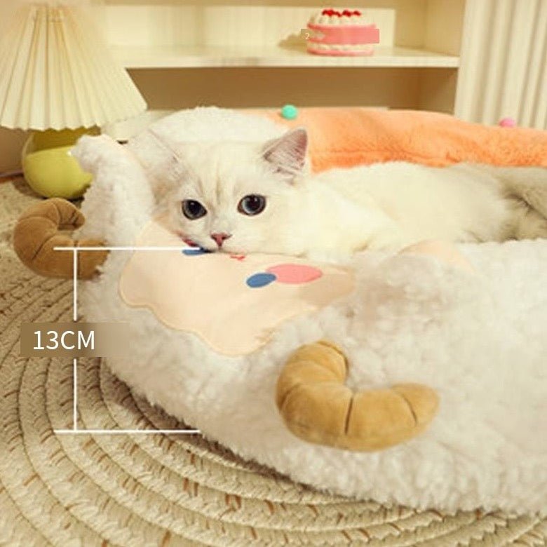 a cat posing on a cat bed with goat design