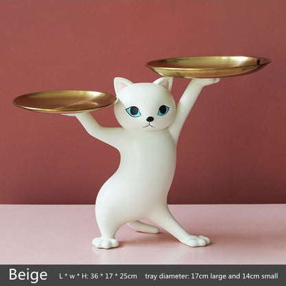 a white cat sculpture of a cat dancing with two trays