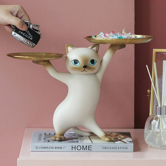 a white cat figure in a dancing pose with 2 trays
