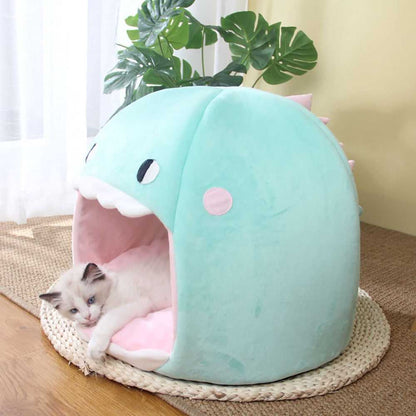 turquoise color dome style cat bed with a cute dinosaur design that is soft and cuddly