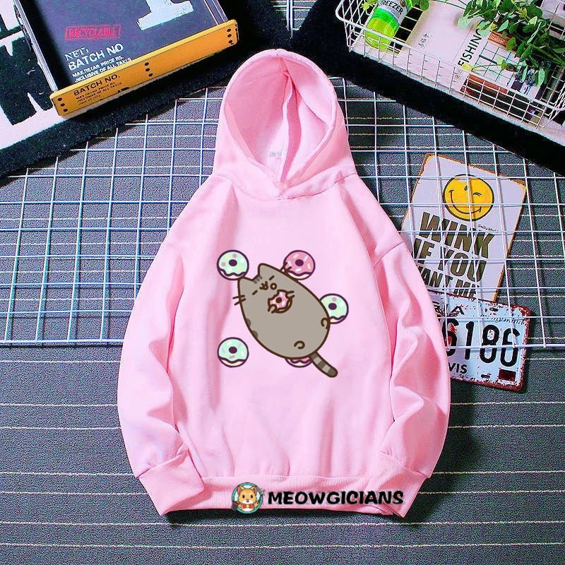 pink cat hoodie made for kids with a cute picture of a pusheen cat holding a donut