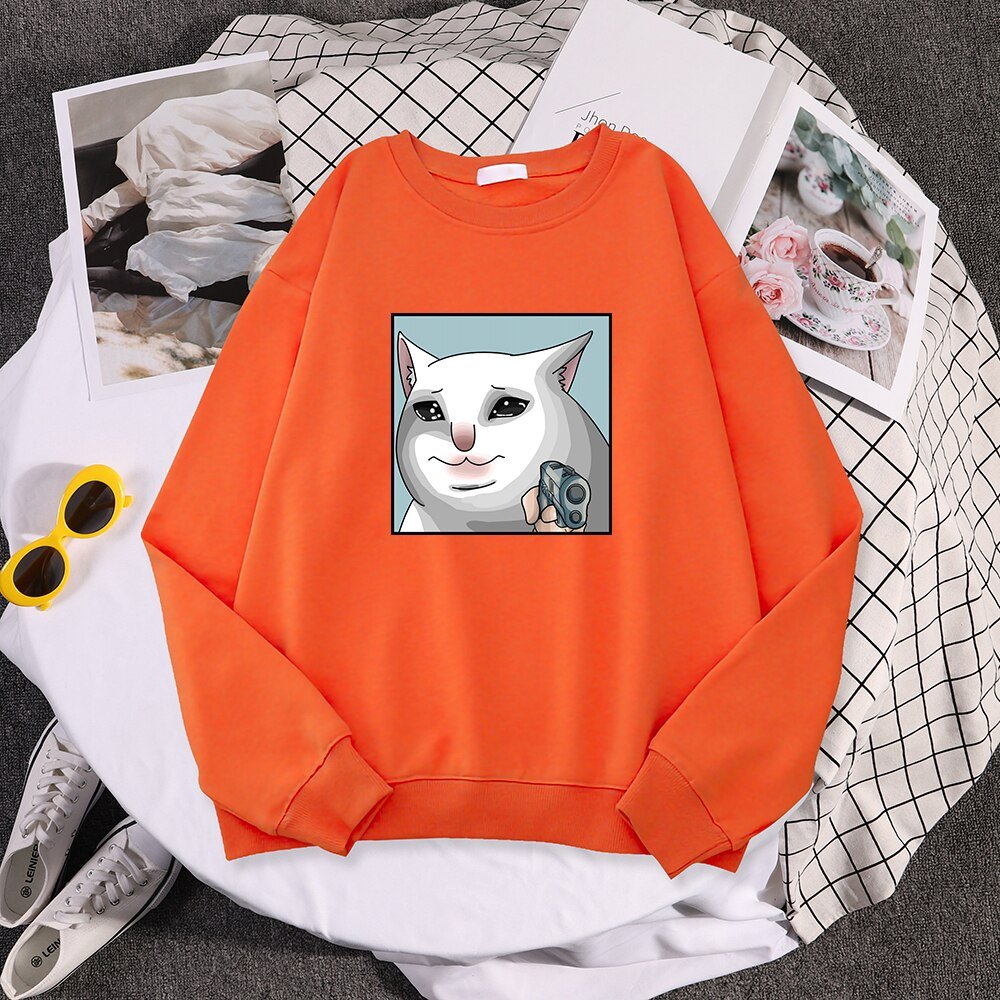 an orange cat lady sweater with a dramatic cat pointing a gun