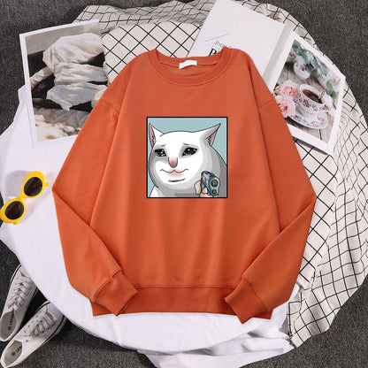 an orange cat print sweater with a dramatic cat