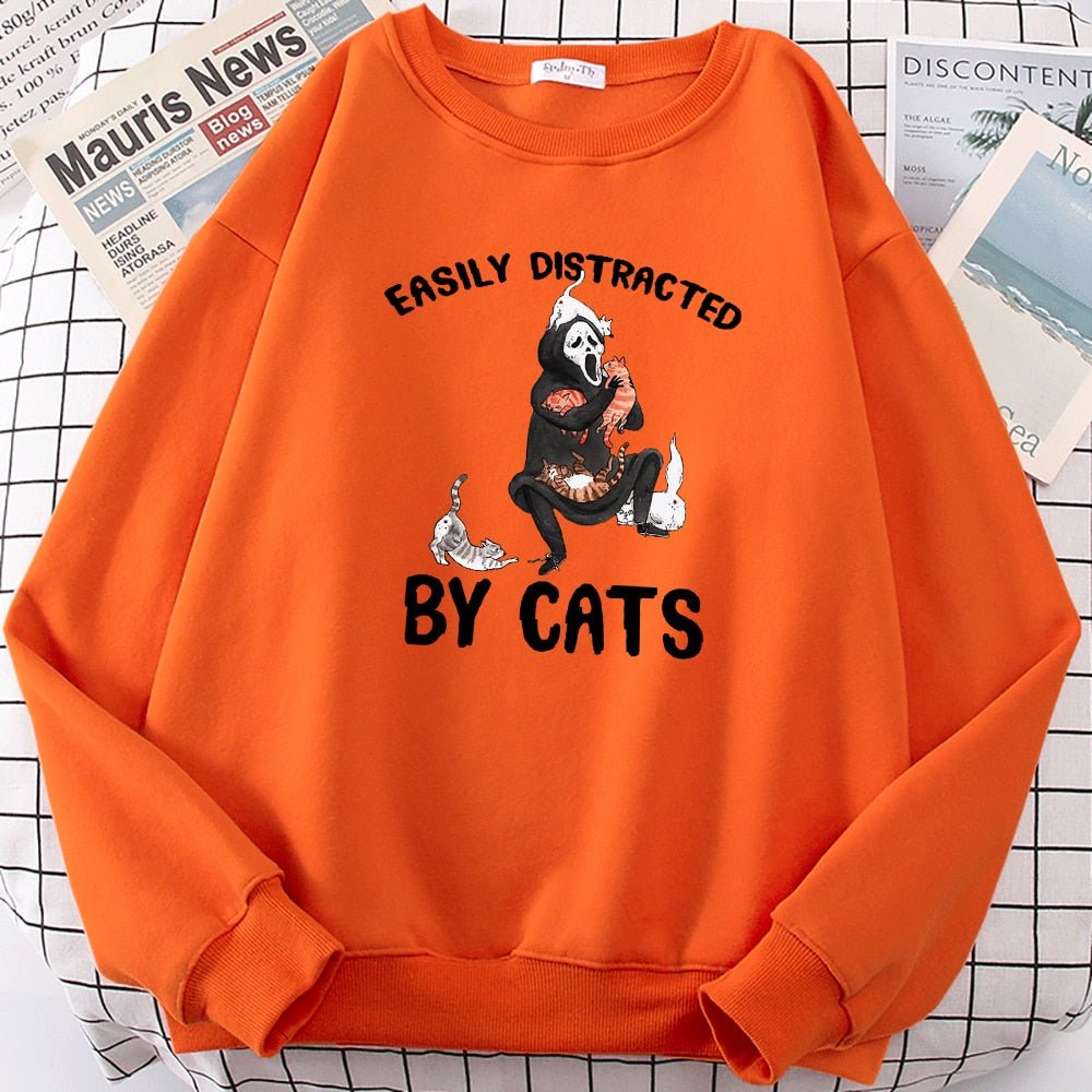 an orange color cat pattern sweater with picture of ghost playing with cats for halloween