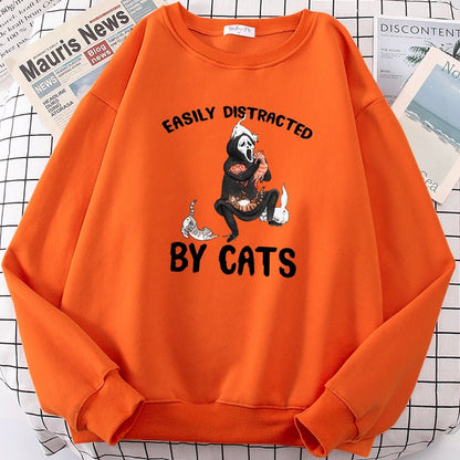 an orange color cat pattern sweater with picture of ghost playing with cats for halloween