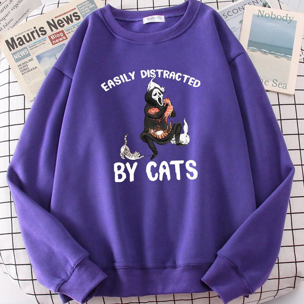 a purple color cat sweaters for humans with picture of ghost getting distracted playing with cats