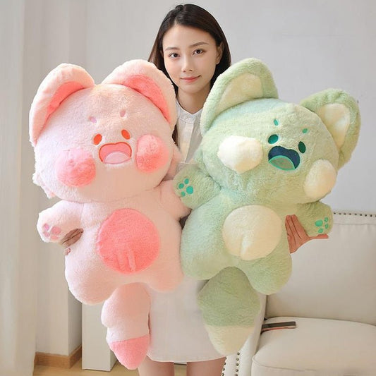 a lady holding a green and pink cat plush