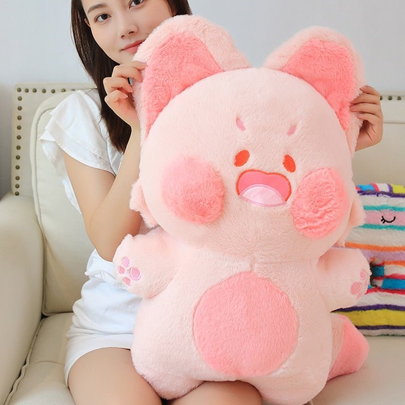 a lady holding a giant cat plush in pink color
