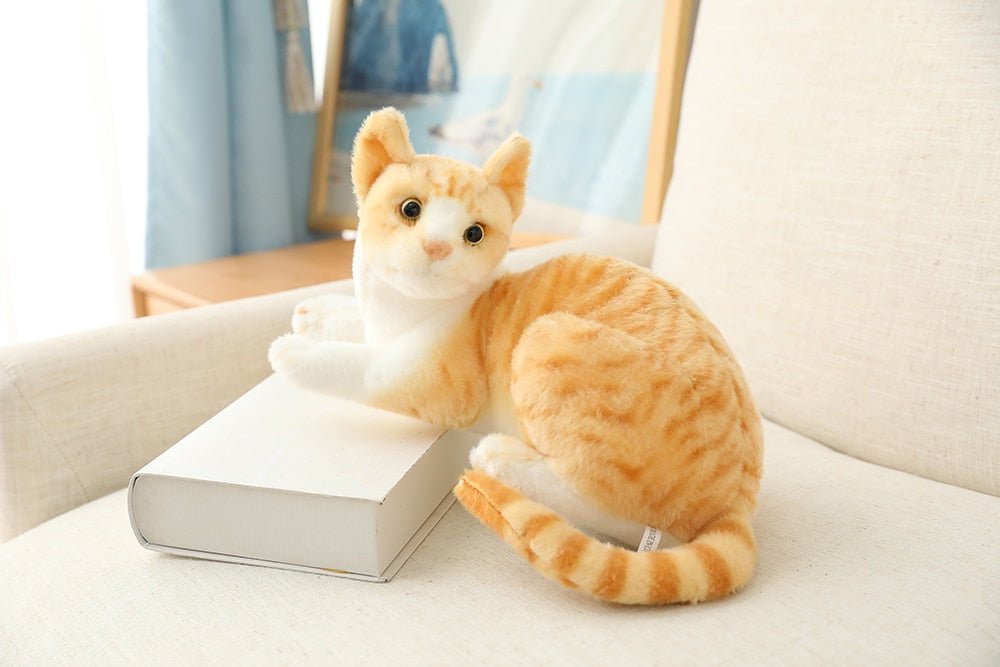 an orange realistic cat plush on a couch