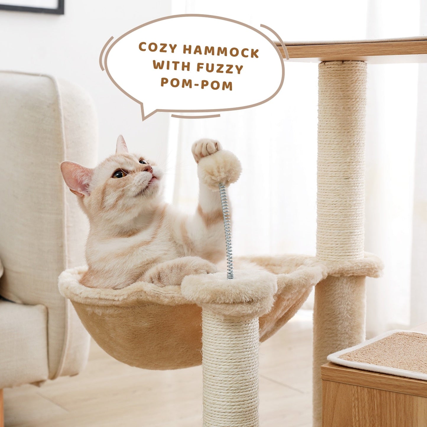 a cat playing with ball from a cat tree with hammock