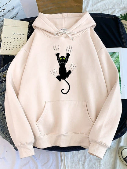 beige color cat hoodie featuring a black cat climbing and scratching up the hoodie that looks very cool and quite realistic