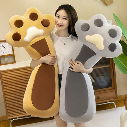 a woman holding big cat plushie in gray and brown