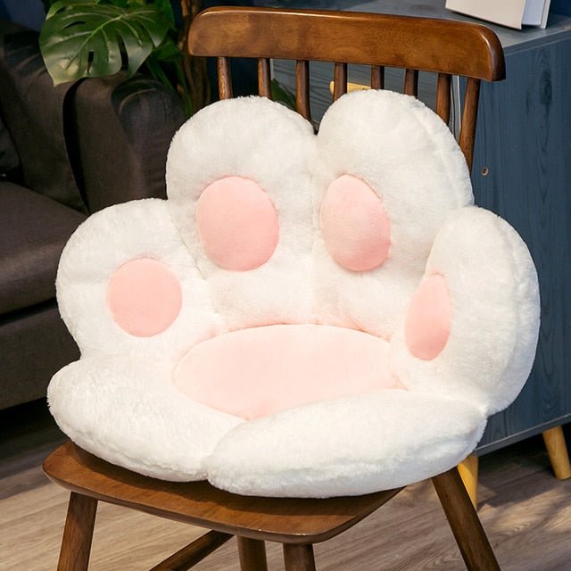 a white and pink color plushie in cat paw shape for chairs