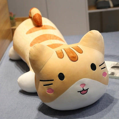 a ginger cat plushies laying down