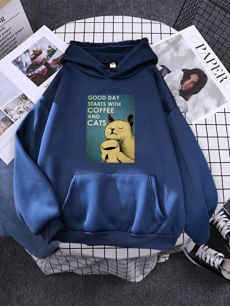 a blue color hoodie with a beige cat drinking coffee to start his day