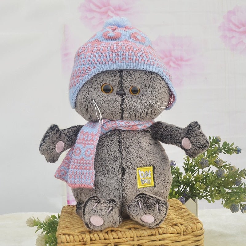 a cute gray cat plush of scottish fold wearing a beanie and scarf