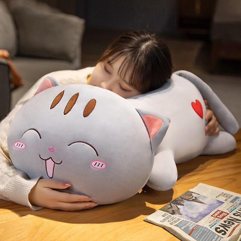 a woman hugging a fat cat plushie 