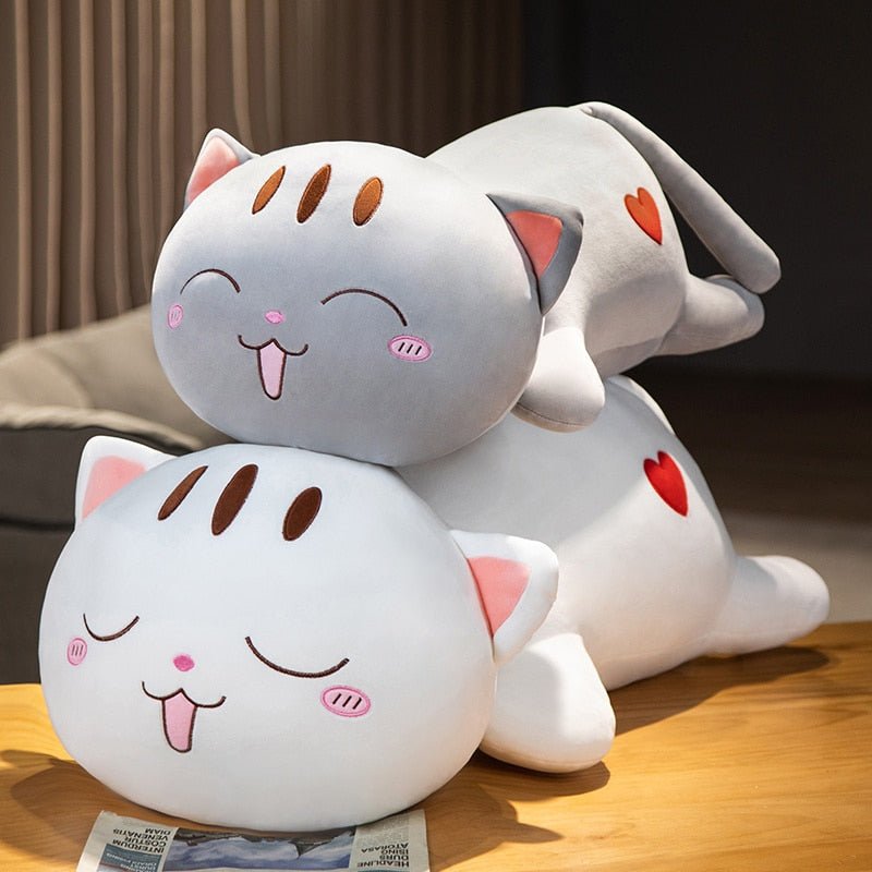 cute plushies of cats on to of each other