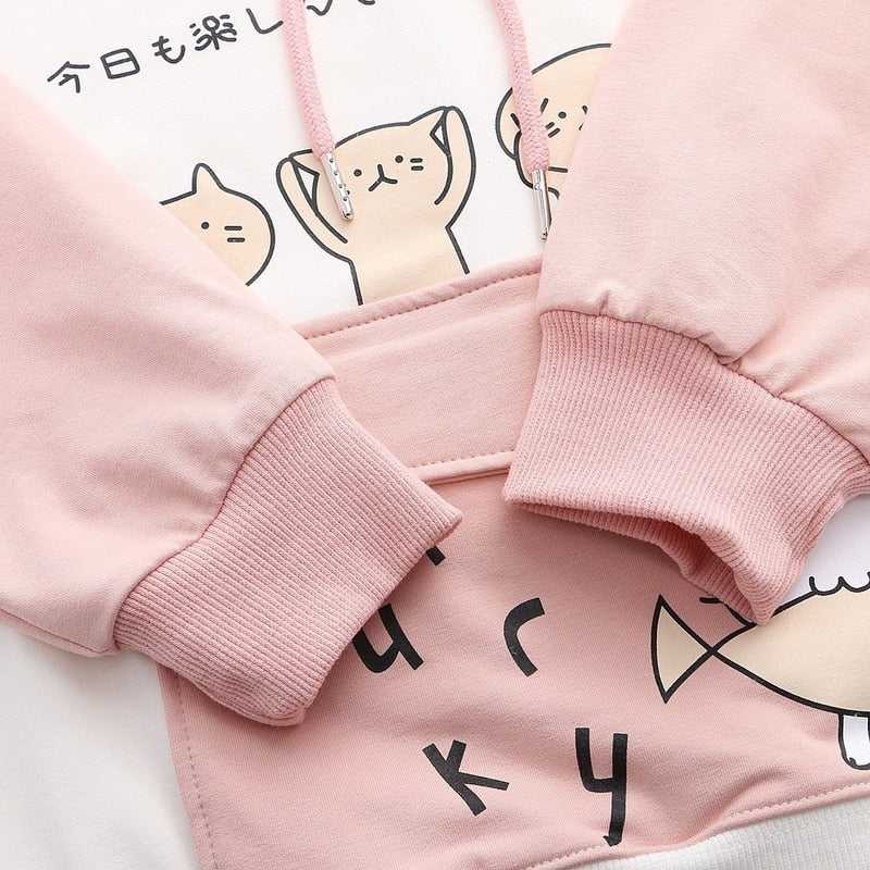 a cute pink womens cat hoodie with cats faces and a cat catching a fish picture on it that looks cute