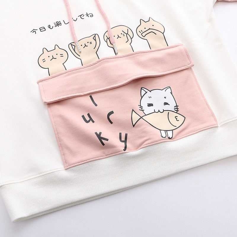 a cute cat pouch from a cat hoodie made for women featuring a cat catching a fish that looks cute