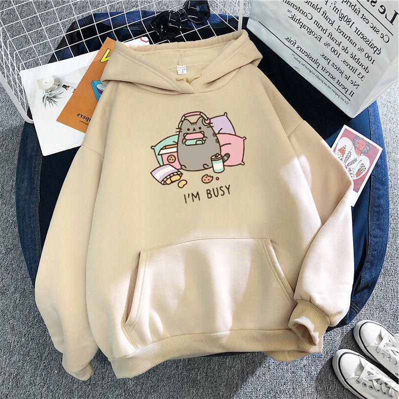 beige color kawaii look cat themed hoodie featuring a cute pusheen cat playing game and listening to music with quote i am busy
