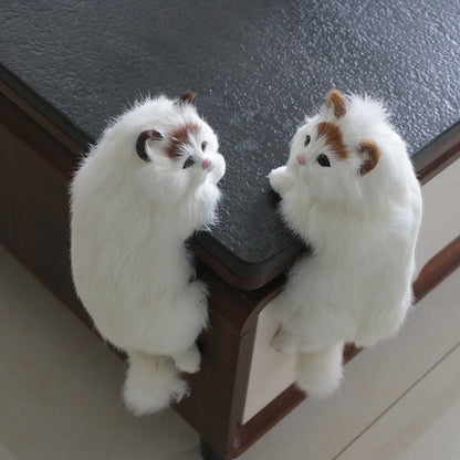 2 ragdoll realistic cat stuffed animals stuck on the table