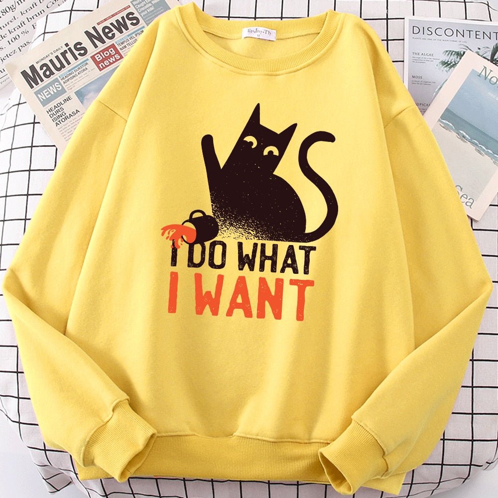 a yellow color cat pattern sweater with a picture of black cat being naughty