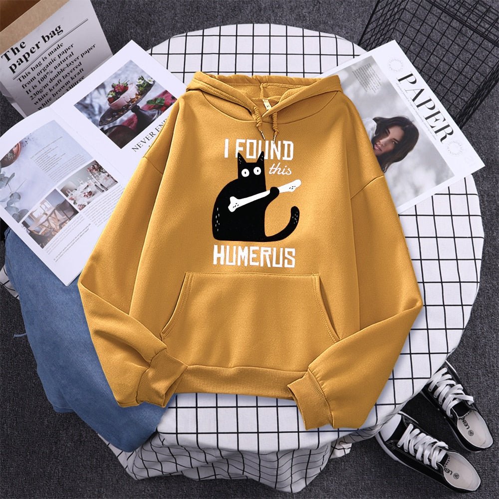 yellow cat hoodie made from cotton featuring a cat finding a bone and find it humerus which is a pun for humorious