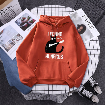 orange color cat hoodie with funny pun of a cat finding a humerus bone