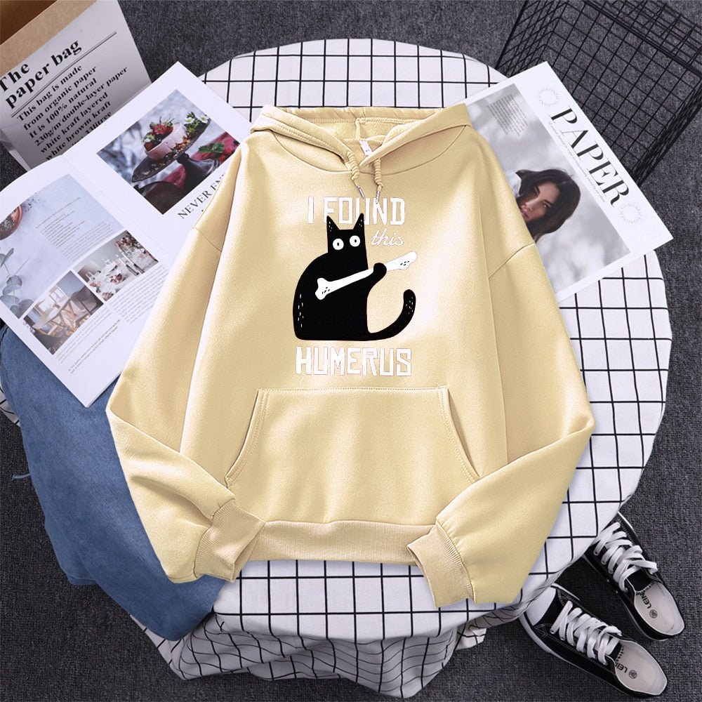 beige color hoodie with a funny cat picture holding a bone