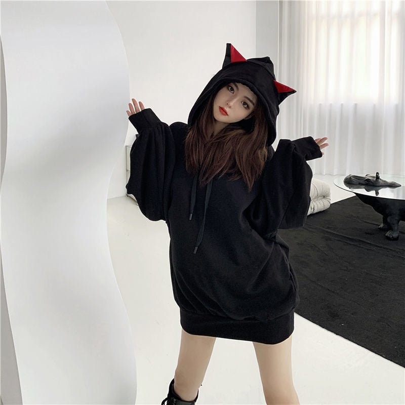 japanese model wearing a black kawaii cat hoodie with ears in cool harajuku style