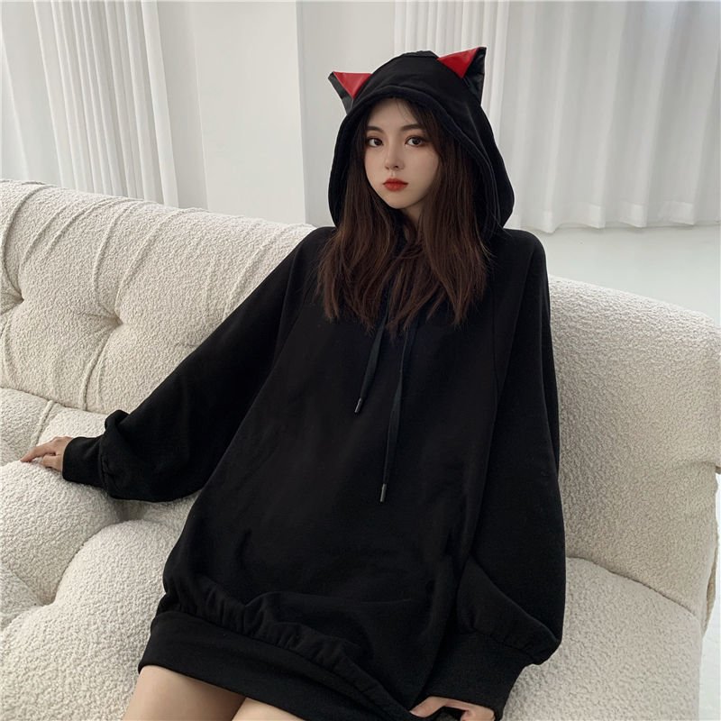 Japanese model wearing a black color cat hoodie with ears in red that look really cool and kawaii