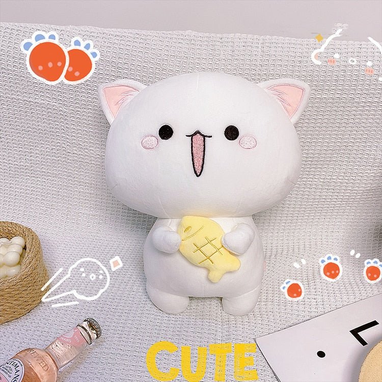 a white with pink cat plush holding a fish