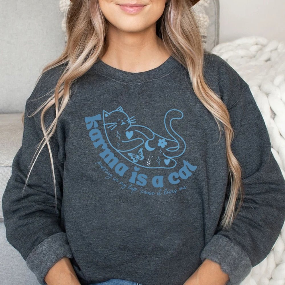 a woman wearing a grey color cat themed sweatshirts with cute karma is a cat designs