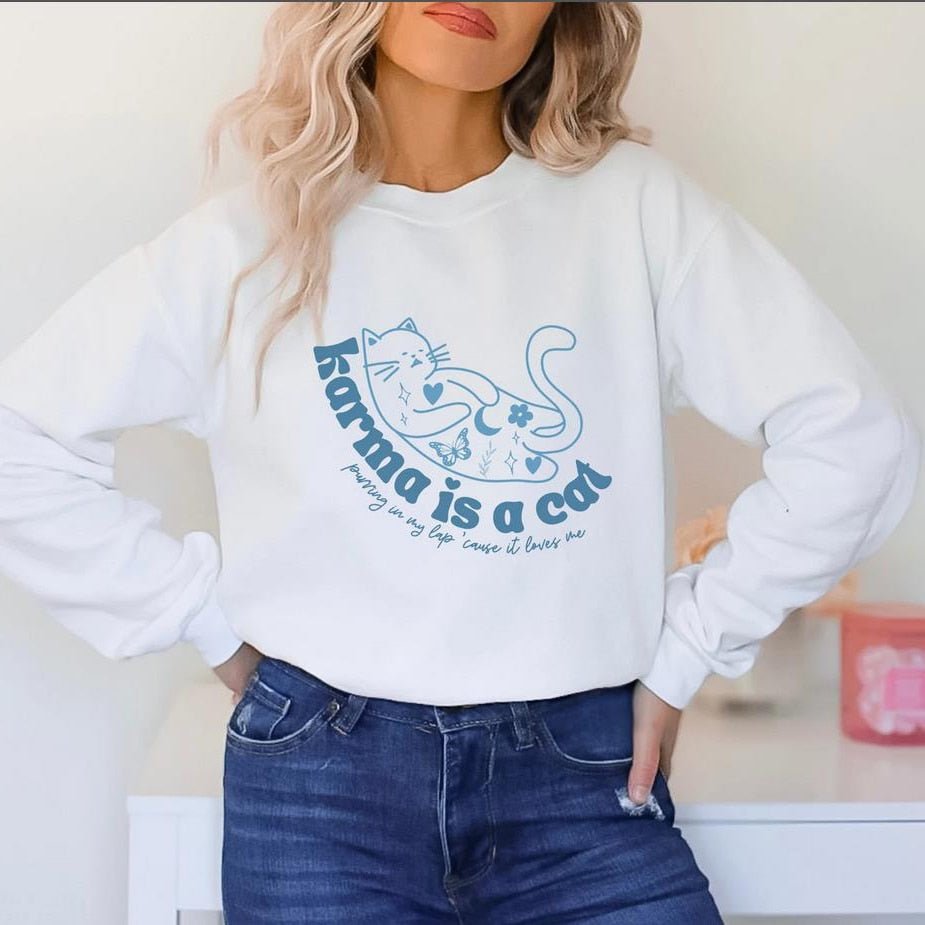 a woman wearing a white cat pattern sweater with cute cat designs