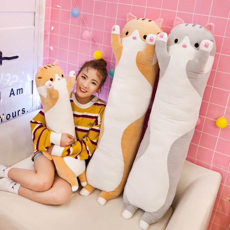 a lady with different sizes of long cat stuffed animal