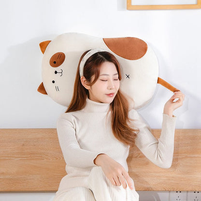 a jumbo cat plush used as a pillow by a lady