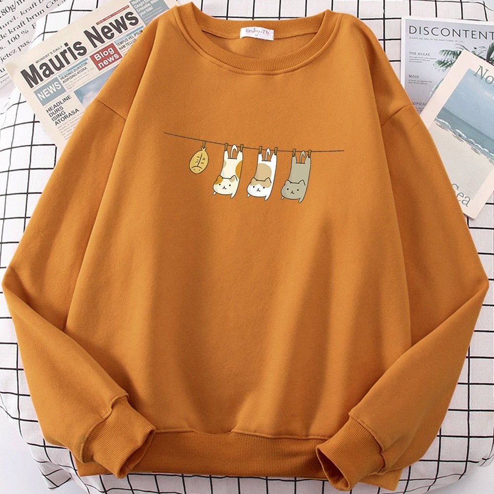 an orange cute cat print sweater featuring cats being the laundry for the day