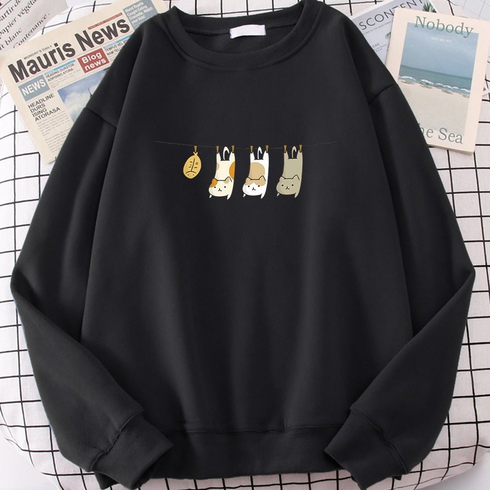a black color cute cat sweatshirt featuring 3 cats and a fish being laundried