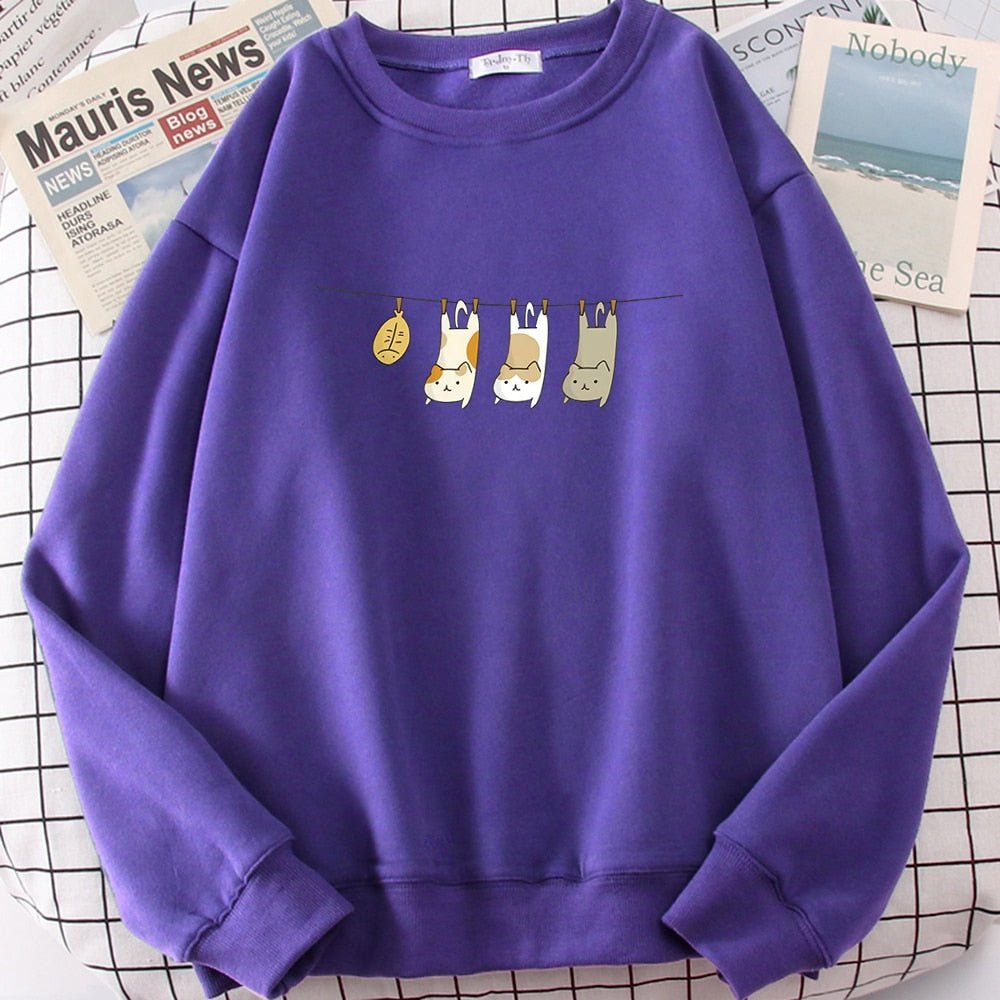 a purple color cat sweatshirts for humans with pictures of 3 cats and 1 fish becoming the laundry