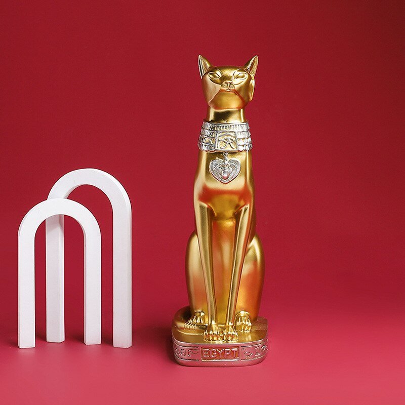 a cat garden statue in golden color with egyptian design and style