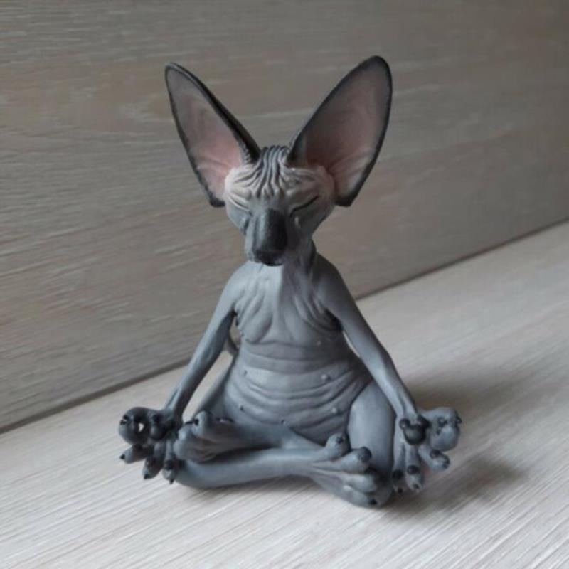 a sphynx cat sculpture doing meditation