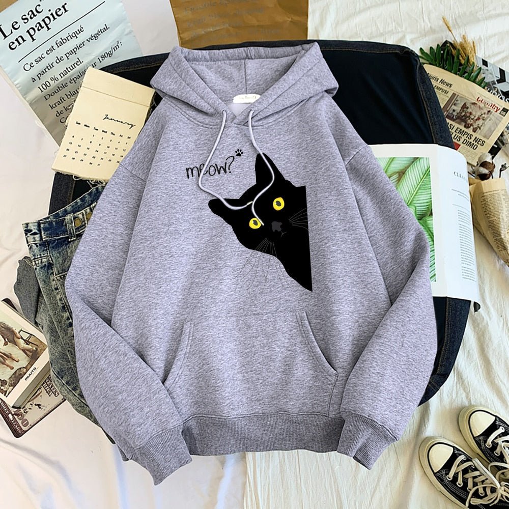 a gray color Warm and cozy unisex hoodie, showcasing a cute and funny design of a sneaky black cat appearing from the corner, with a comical 'Meow?!' quote