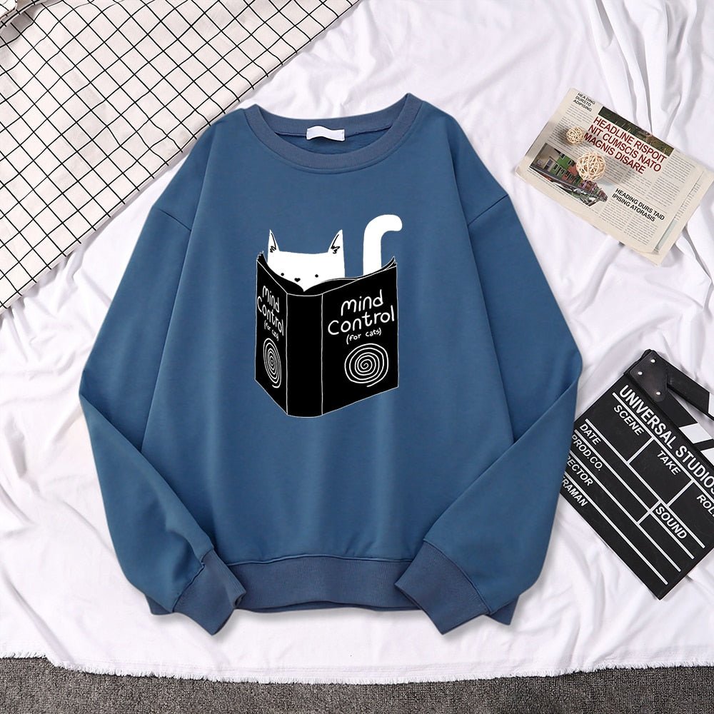 a blue cat pattern sweater with a cat reading a book picture