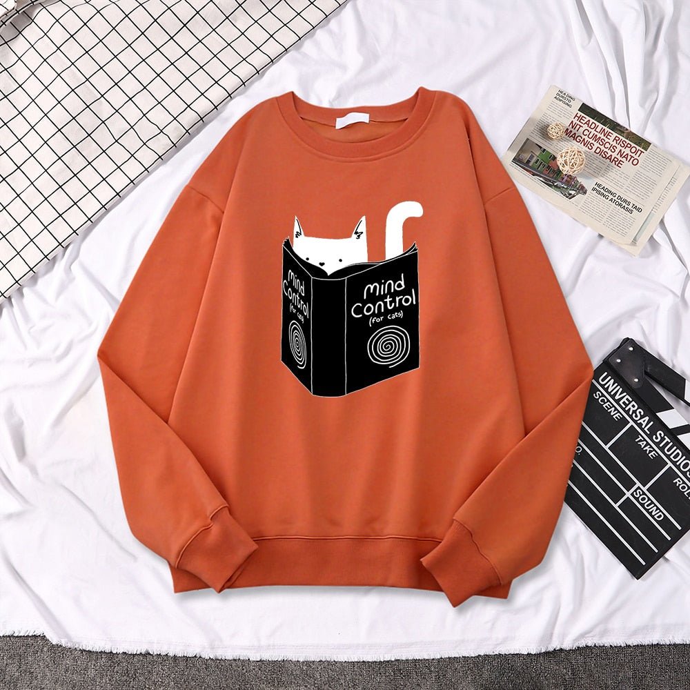 an orange cat themed sweatshirts with a cat reading a book