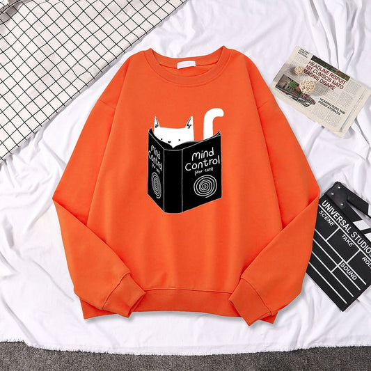 an orang sweatshirt with cat reading a book about mind control