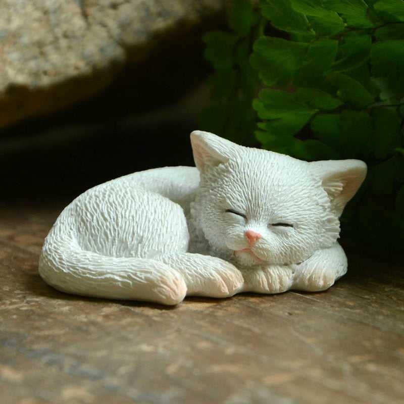 a realistic white sleeping cat sculpture with attention to details on the fur