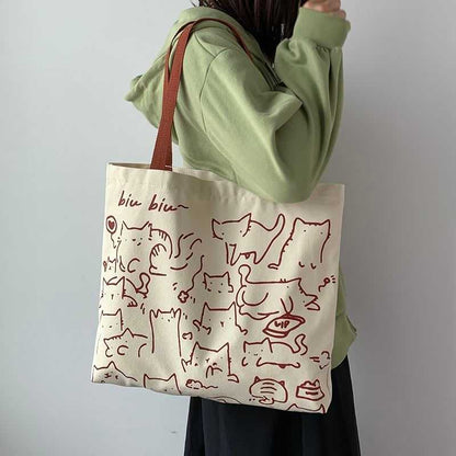 lady carrying a tote printed with a lot of cute cat cartoon, with biu biu words on it