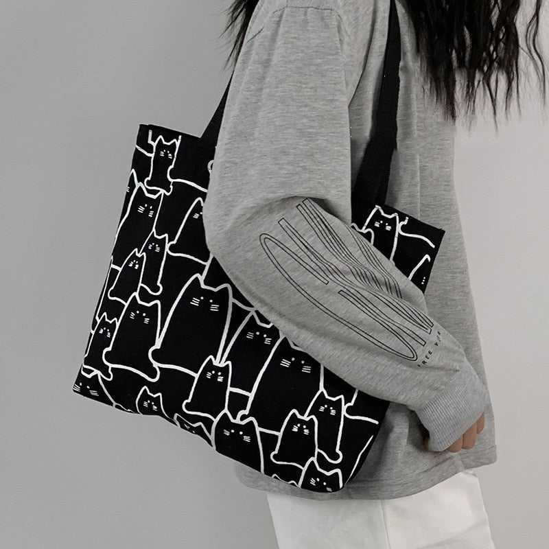 Minimalist Cat Tote Bag in Black Color, printed with a lot of abstract cartoon cat with no mouth and looks so adorable