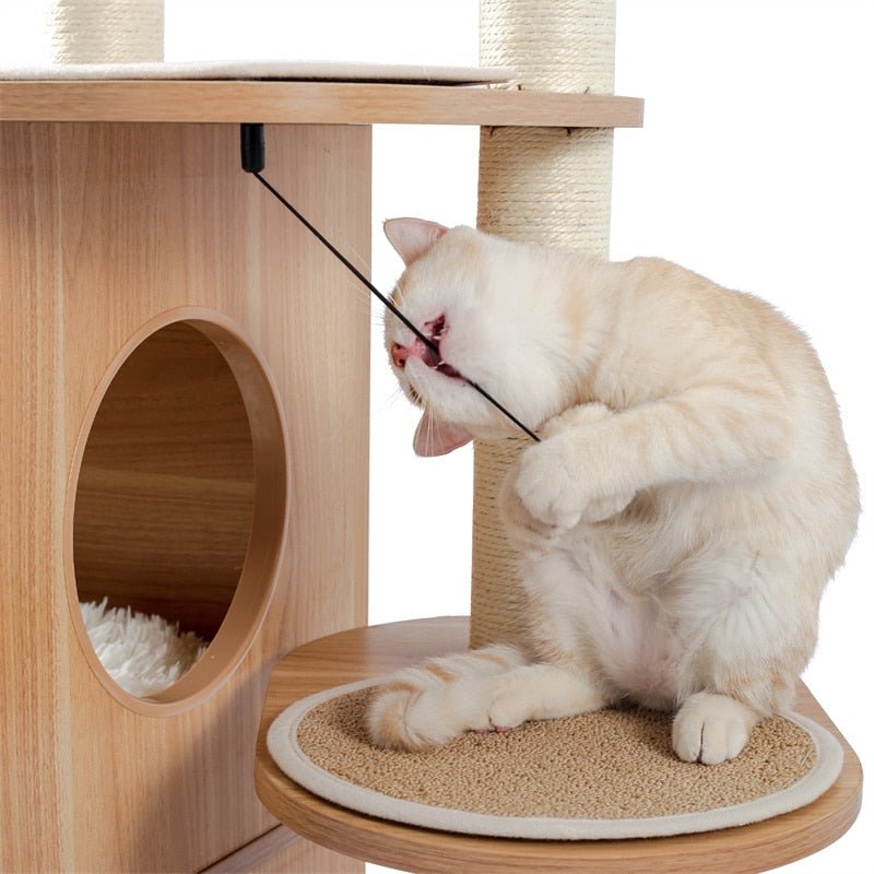a cat playing fur ball on a cat tree from meowgicians